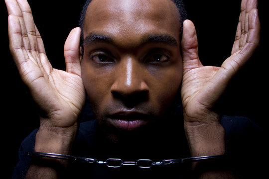 close up portrait of hand cuffed black man