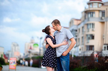 Happy young couple kissing in the city