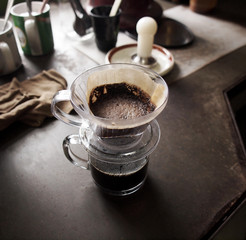 Cup of Dripping coffee on table