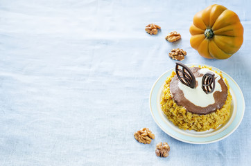 Obraz na płótnie Canvas pumpkin cheesecake with chocolate and walnuts