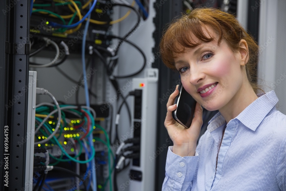 Poster Technician talking on phone while analysing server