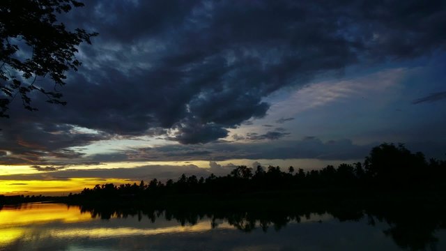 Sunset over thailand river among nature green field time-lapse