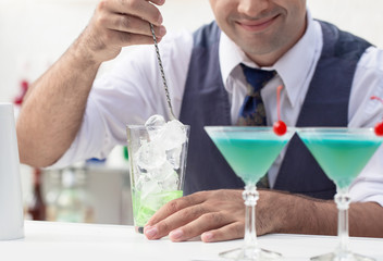 bartender pouring a cocktail drink