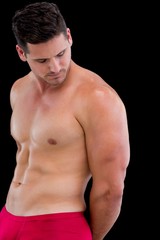Fototapeta na wymiar Side view of a shirtless muscular man