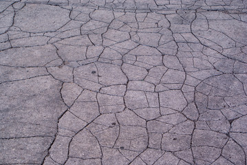 Old road background - surface of cracked asphalt texture