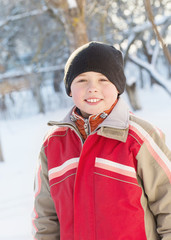 portrait of a cute boy in winter park