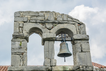 Ancient bell hanging on a stone arch, Buzet, Croatia - 69367397