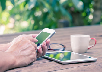 Hands texting mobile phone, vintage color effect