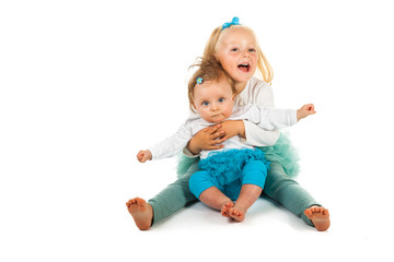Preschool girl holding infant girl