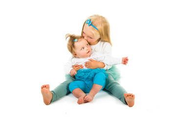 Preschool girl holding infant girl