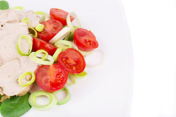 Chicken salad with tomatoes and leek.