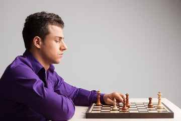 Man playing chess on white background.