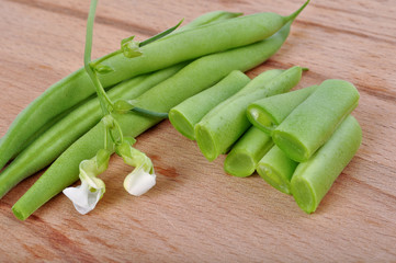 Green beans on wooden background