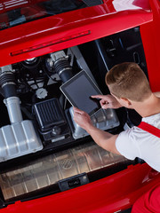 Mechanic inspecting the engine of a car