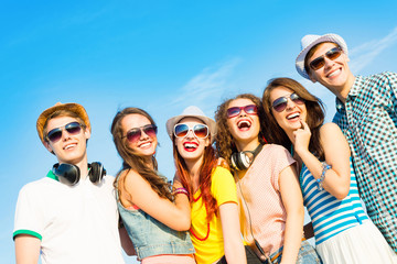 group of young people wearing sunglasses and hat