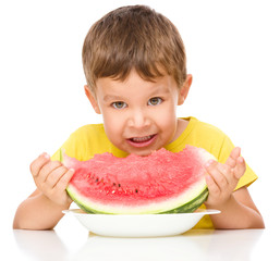 Little boy is eating watermelon