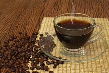 Coffee cup and coffee beans on old wooden background