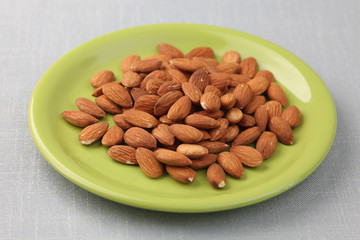Almonds on a green plate