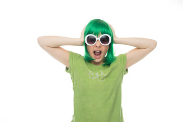 Fun young girl in a green wig and sunglasses