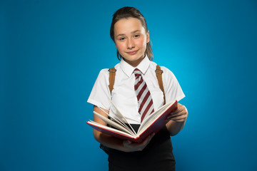 Schoolgirl with a lovely smile holding a book