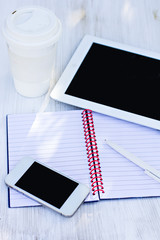 diary, mobile phone, tablet PC and glass of coffee