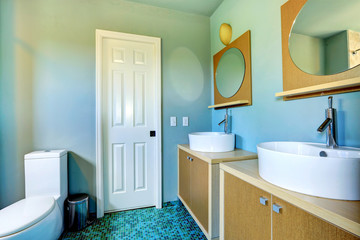Fototapeta na wymiar Bathroom vanity cabinets with vessel sinks and round mirrors
