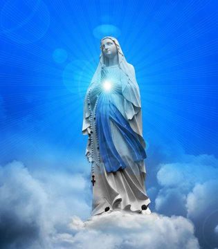 Madonna statue with blue sky and clouds background