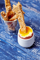 Toast soldiers dipped in boiled creamy egg