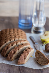 sliced ​​ rye bread with a knife, walnuts, pear, pepper,verti