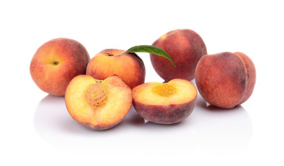 Many peaches with leaf isolated on white