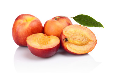 Few sliced nectarines with leaf isolated on white