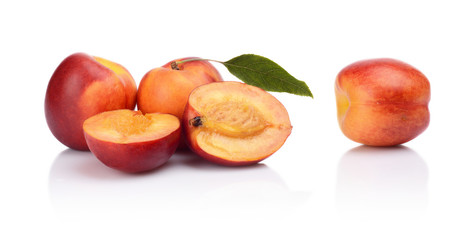 Few sliced nectarines with leaf isolated on white