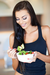 Young woman eating a healthy fresh salad