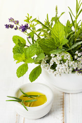 Fresh rosemary with olive oil and bouquet of herbs