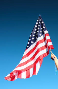 Hand holding american flag