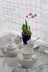 Ceramic utensils on table with flower