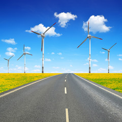 Asphalted road with wind turbines