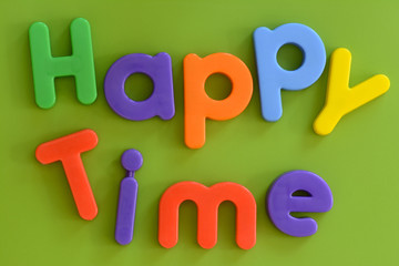 Close up of words Happy Time in colorful plastic letters