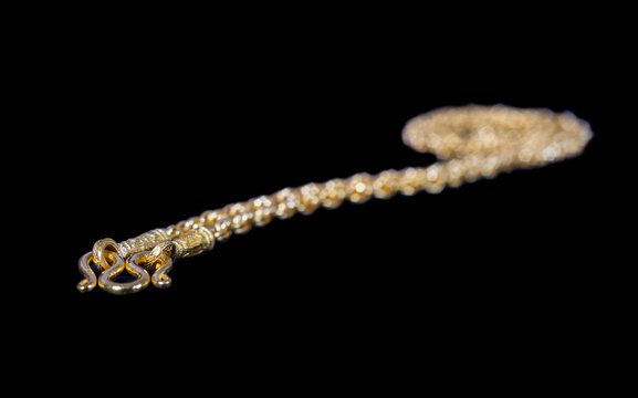 Golden Necklace Closure On Black Background