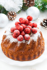 Christmas cake on a plate and decorations, close-up, top view