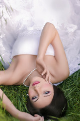 Obraz na płótnie Canvas Beautiful bride with stylish make-up in white dress