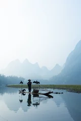  Cormorant, fish man and Li River scenery sight with fog in sprin © cchfoto