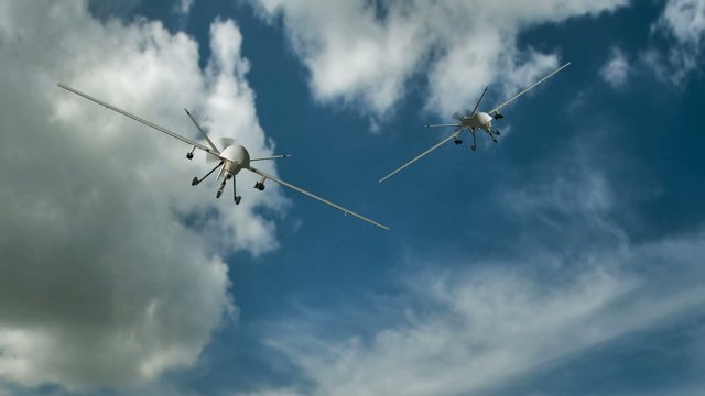 two armed predator drones in flight on the camera