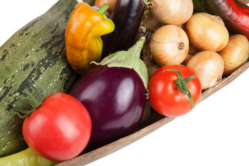 assorted vegetables lying in a wooden scoop isolated on white ba