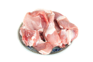 raw pieces of pork meat on a plate isolated on white background