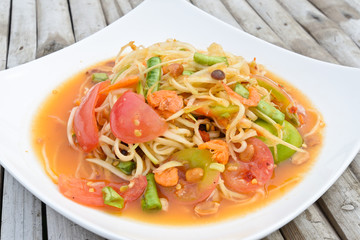 green papaya salad in white dish