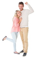 Attractive couple smiling and cheering