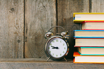 Alarm clock and books.