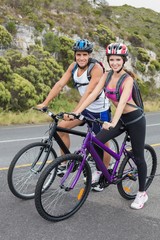 Fototapeta na wymiar Athletic couple mountain biking