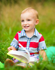 Little boy is reading book